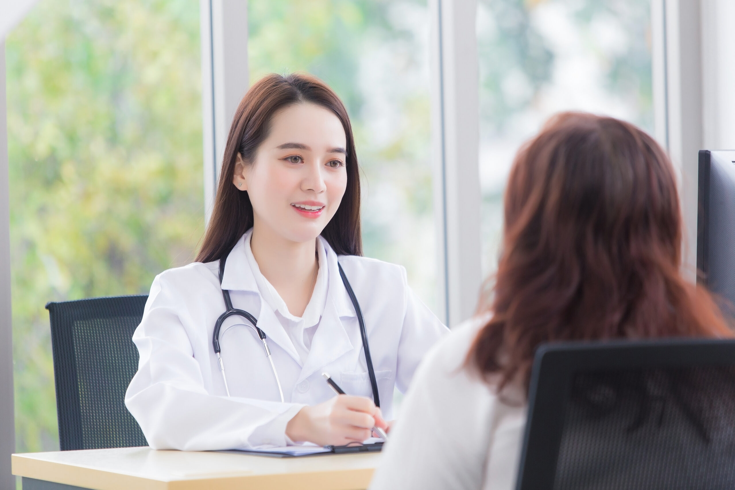 Doctor consulting patient at aesthetic clinic in Bangkok